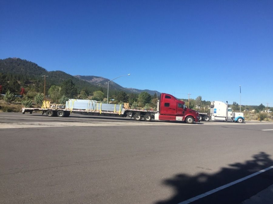 flatbed trailer loaded with construction material in Reno going to Clatskanie, OR