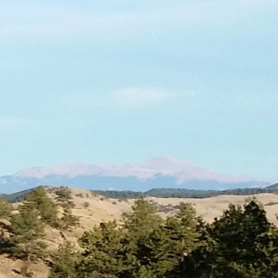 long-distance photo of the backside of Pike's Peak on a sunny day