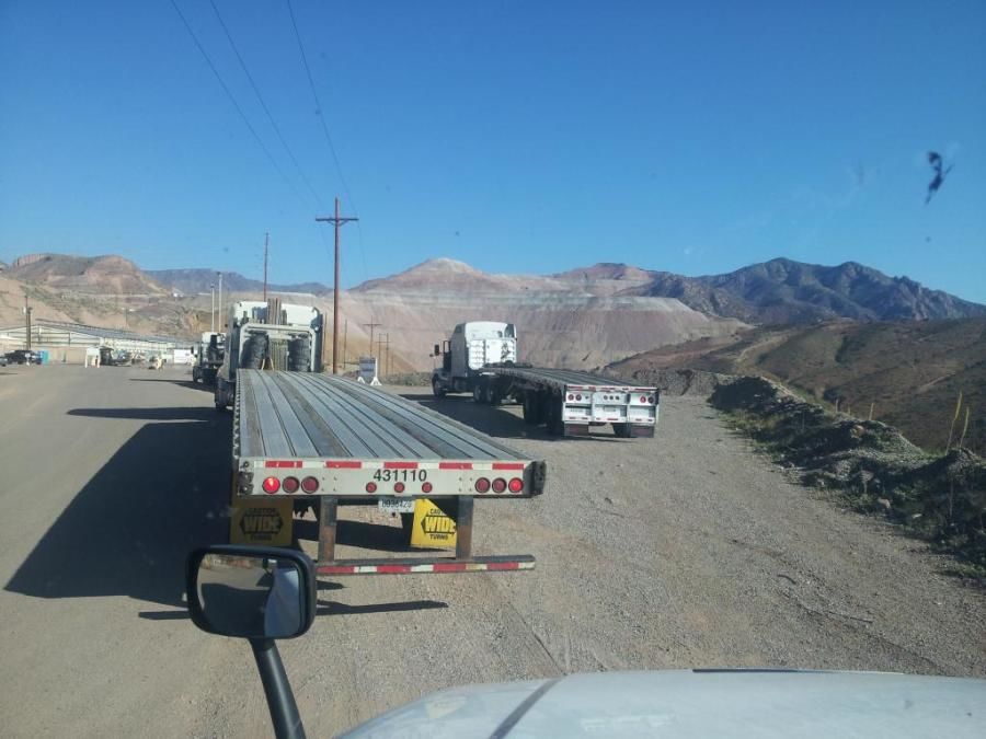 flatbed trucks waiting to pick up loads of copper from copper mine