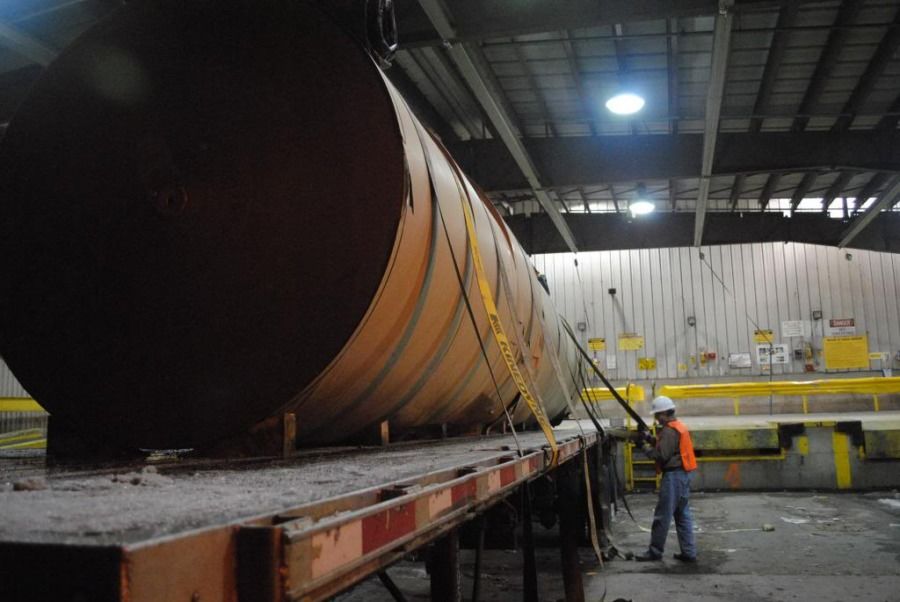 flatbedder strapping paper rolls bound for a Sheetrock plant in Bridgeport Alabama