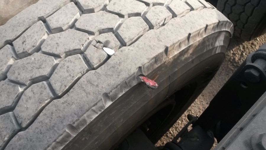 a chisel embedded in a punctured truck tire