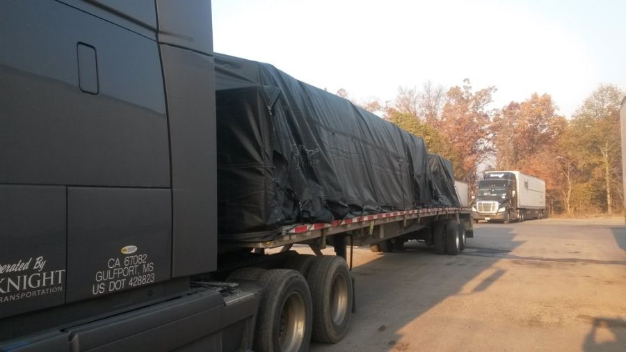 multi-stop Knight flatbed trailer load tarped in the parking lot