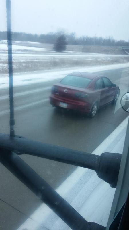 little red mazda about to crash in to tractor trailer on the highway