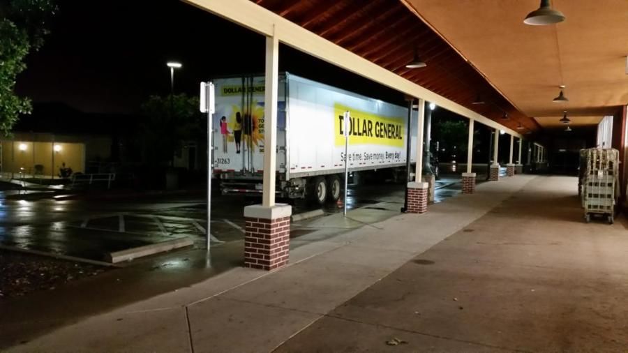 Werner truck and Dollar General trailer delivering in front of store