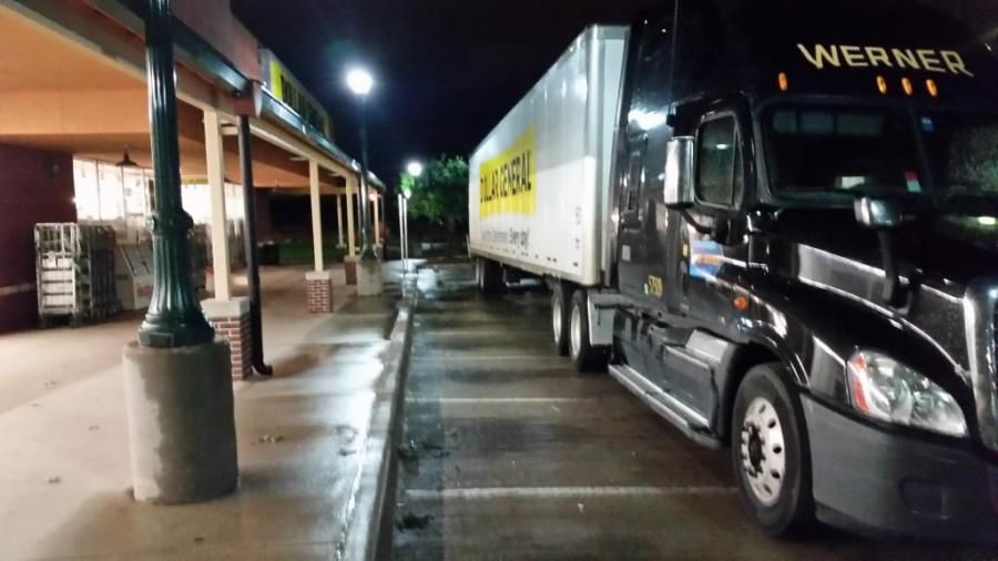 Werner truck and Dollar General trailer delivering in front of store