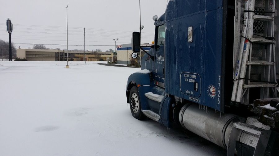 blue Melton truck parked in the snow and ice
