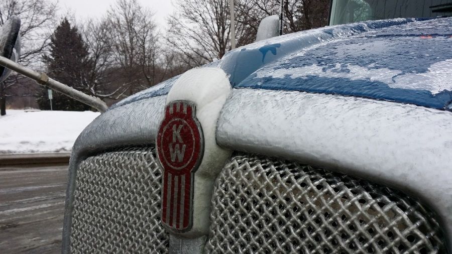 Blue Melton Kenworth flatbed truck grill iced over from Pennsylvania ice storm