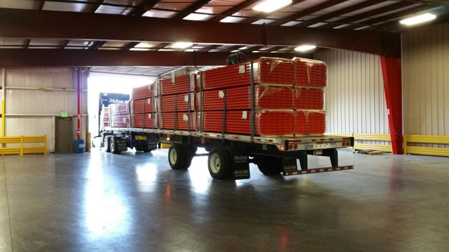 flatbed trailer in loading dock loaded with shelving for WalMart distribution center