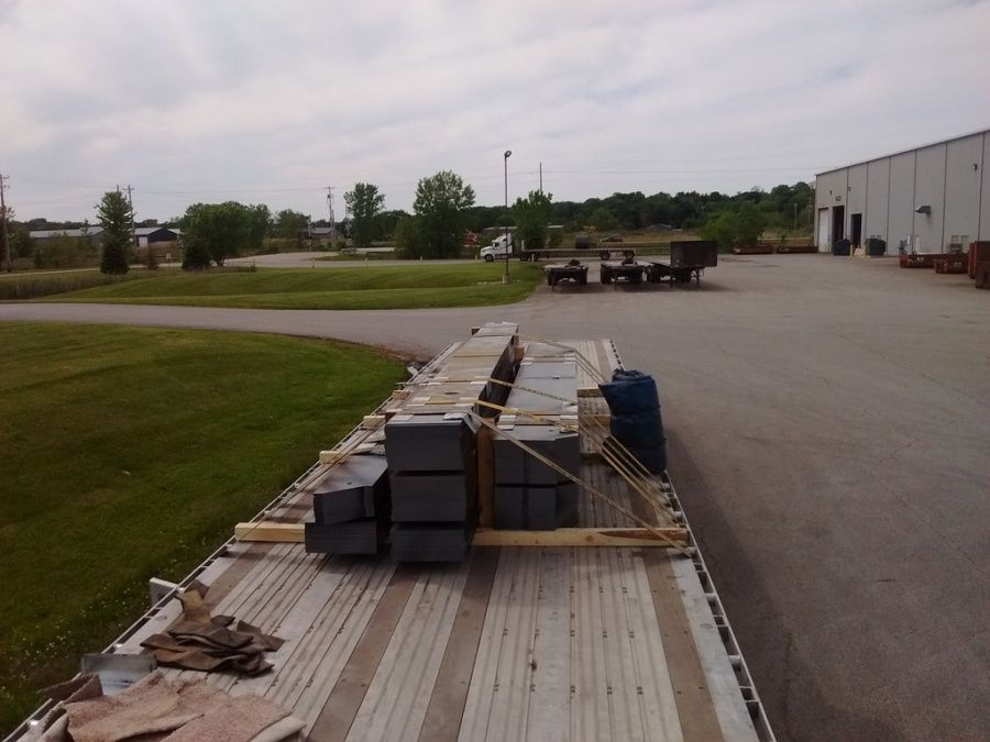 flat steel loaded and strapped on flatbed trailer at Olympic Steel