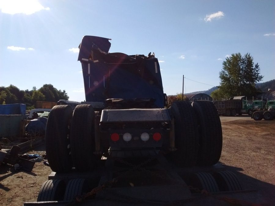 truckers pictures of his wrecked and crushed flatbed truck after he rolled it in an accident