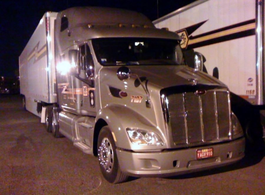 shiny new gray peterbilt truck at night