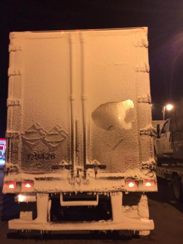 tractor trailer covered in snow