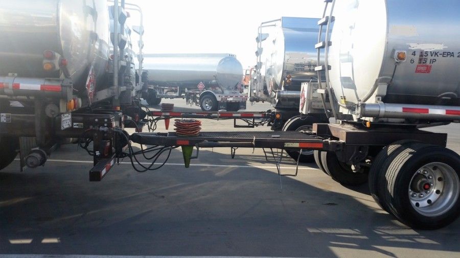 shiny chrome tanker truck pulling 2-axle tank trailer