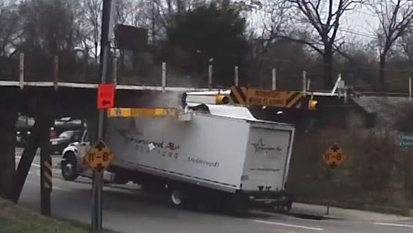 box truck hits and gets stuck under low-bridge