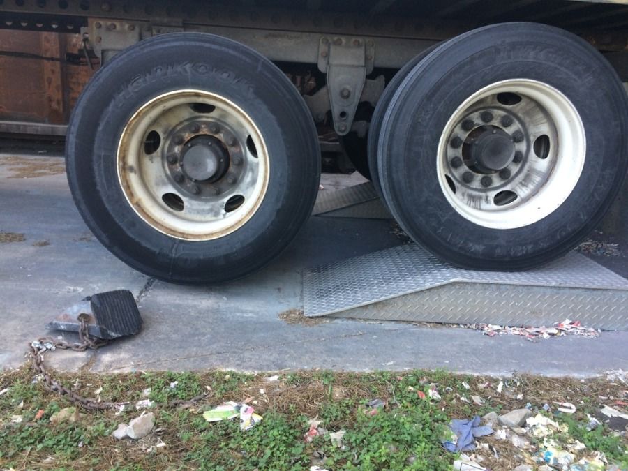 semi trailer wheels on ramp at dock