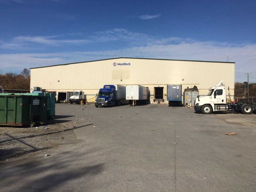 trucker at customer in west rock knoxville tennessee looking at dock with trucks parked