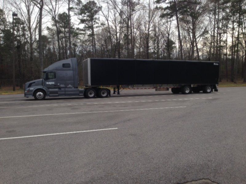 sapa truck pulling a sliding tarp flatbed