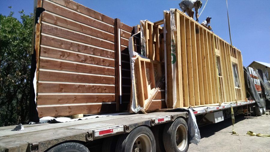 construction house framing loaded on flatbed