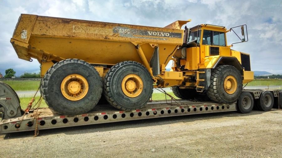giant mining dump truck loaded on a flatbed trailer