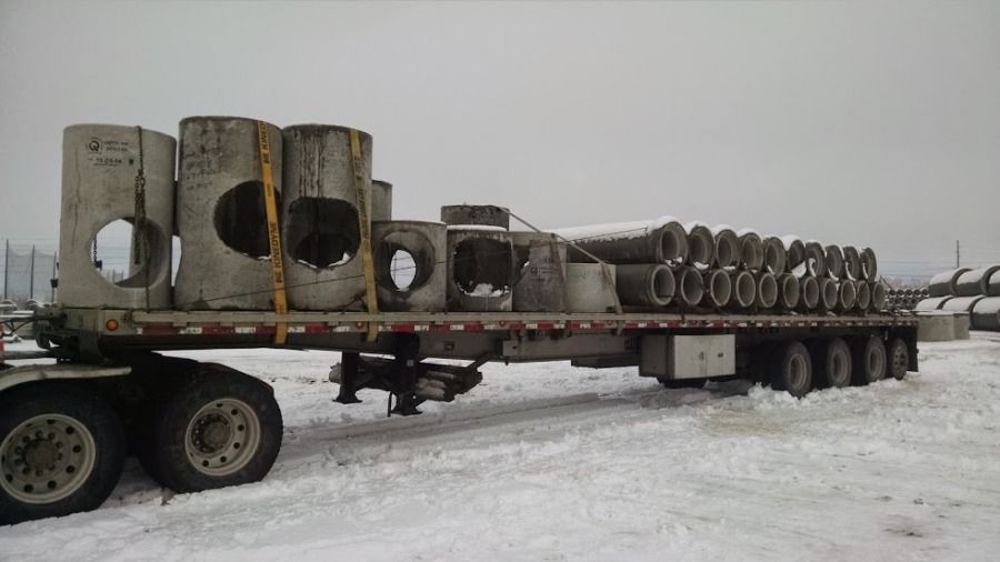flatbed trailer loaded with cement pipe