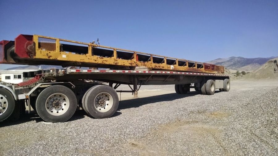 flatbed trailer loaded with rock shaker