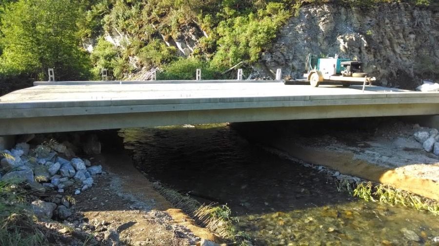 new bridge section being built over a stream