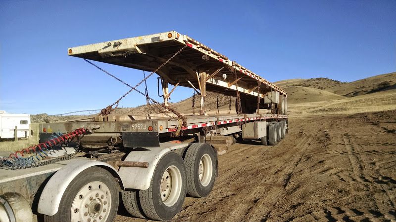 flatbed trailer loaded on extended trailer in Montana