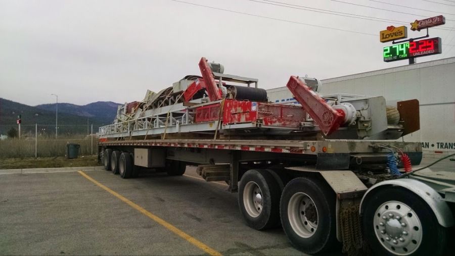 conveyor equipment loaded and secured on extended stretch flatbed trailer