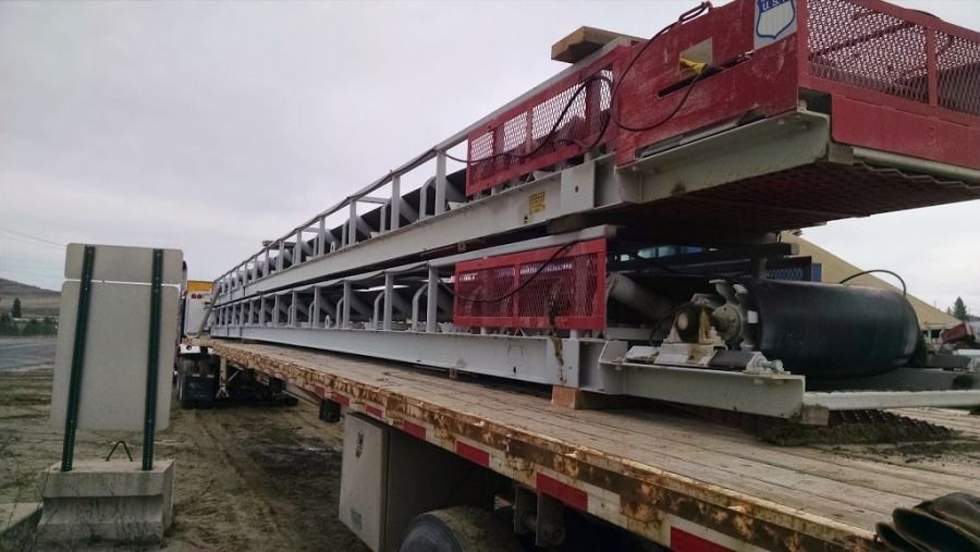 conveyor equipment loaded and secured on extended stretch flatbed trailer