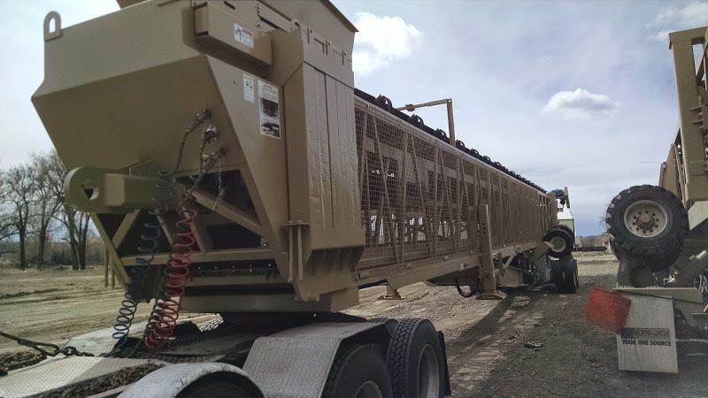over-length conveyor trailer being hauled