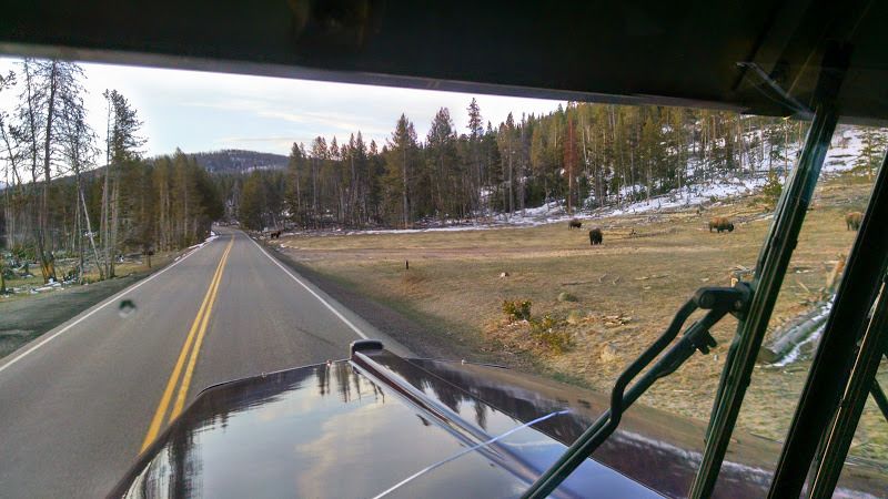 truckers view of the open road and snow covered mountains