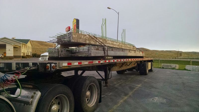 flatbed loaded with cement bridge pieces
