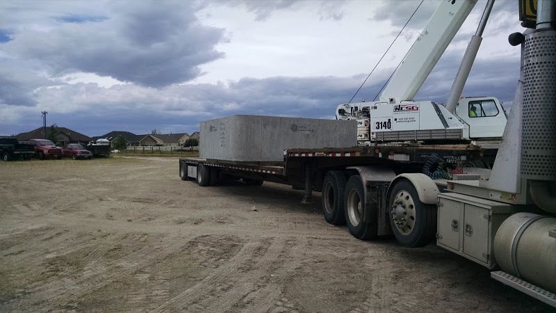 flatbed trailer loaded with large cement box