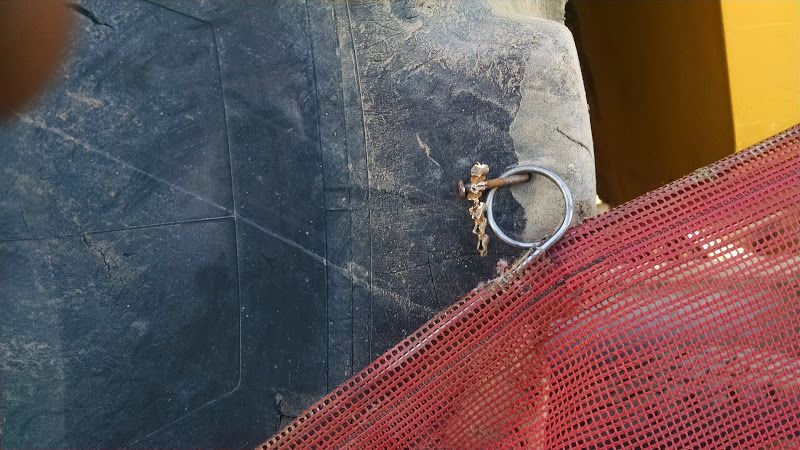 nail in tire used to secure flag on oversized piece of construction equipment loaded on flatbed trailer