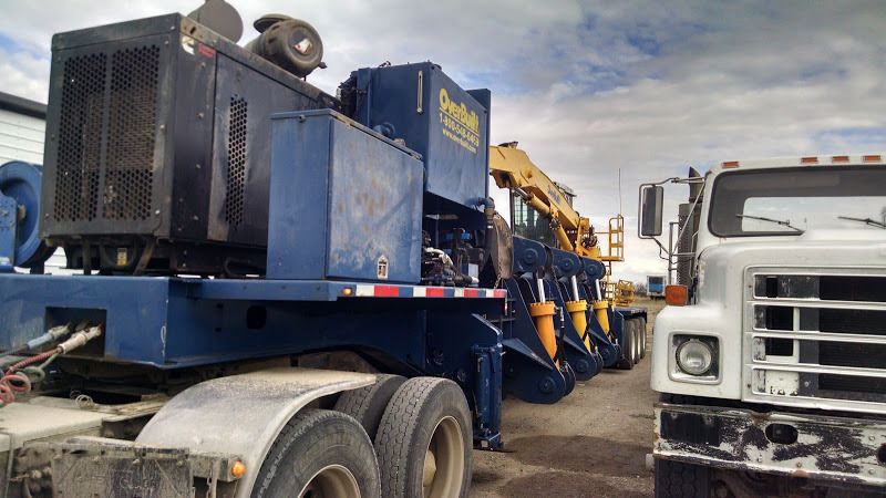John Deer 350 excavator and metal recycling baler loaded on flatbed trailer