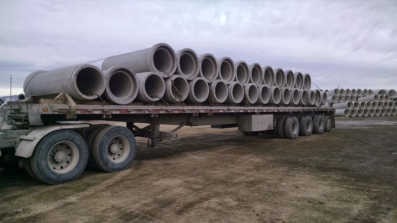 cement bell-end pipe loaded and secured on a flatbed trailer