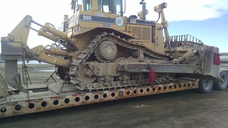 D8 CAT bulldozer loaded on flatbed trailer