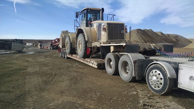 980 CAT loader loaded on flatbed trailer