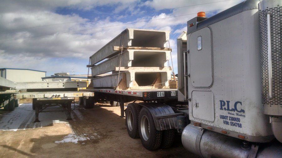 flatbed trailer loaded with cement bridge pieces