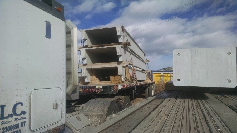 flatbed trailer loaded with cement bridge pieces