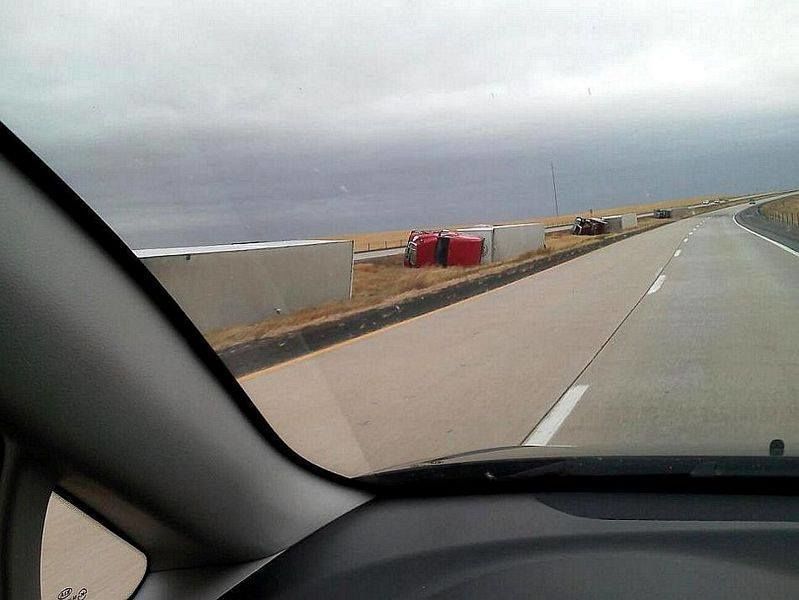 picture of trucks knocked over by the wind
