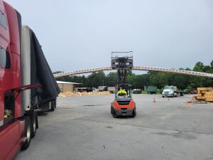 Forklift handling long beams.